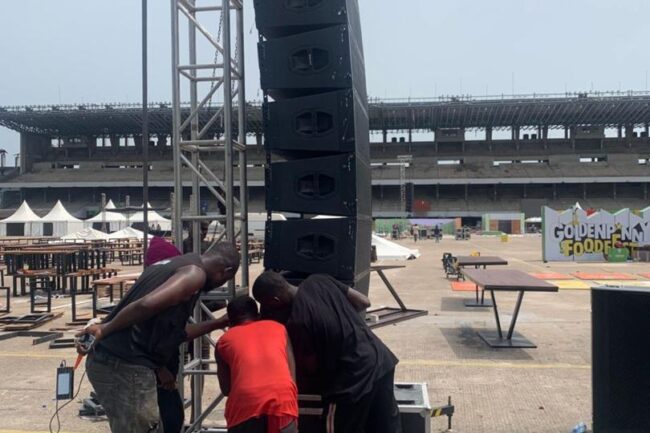 team members setting up the delay line array speakers at tbs